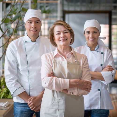 Female Business Owner with Two Chefs